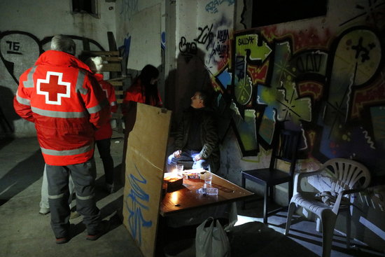Red Cross workers at a warehouse where people live (by ACN)